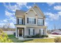 Charming two-story home featuring manicured lawn, beautiful architectural details, and inviting curb appeal at 19 Tobenton Ct, Clayton, NC 27520