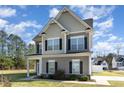 Charming two-story home featuring manicured lawn, beautiful architectural details, and inviting curb appeal at 19 Tobenton Ct, Clayton, NC 27520