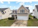 Charming two-story home with a two-car garage, and inviting curb appeal at 1945 Red Quartz Dr, Raleigh, NC 27610