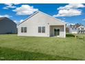 The back of the house with two windows and sliding glass doors overlook the spacious backyard at 195 Hawksmoore Ln, Lillington, NC 27546