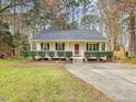 Cozy single-story home with yellow siding, green shutters, and well-manicured front lawn at 204 Sugarland Dr, Apex, NC 27502