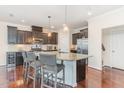 Spacious kitchen features stainless steel appliances, dark cabinetry, and granite countertops at 2418 Pecan Ridge Way, Apex, NC 27502