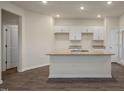 Kitchen featuring white cabinets, granite countertops, and stainless steel sink at 261 Canopy Dr, Graham, NC 27253