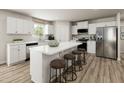 Contemporary kitchen features a center island with seating and stainless-steel appliances. Wood floor at 27 Artesa Ct, Fuquay Varina, NC 27526