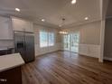 Dining area with sliding glass doors to the deck, modern light fixture, and stainless refrigerator at 3273 Argyll Dr, Sanford, NC 27332