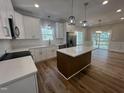 Modern kitchen featuring white cabinets, stainless steel appliances, and a center island at 3273 Argyll Dr, Sanford, NC 27332