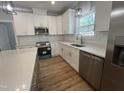 Bright kitchen with white cabinets, subway tile backsplash, and stainless steel appliances at 3273 Argyll Dr, Sanford, NC 27332