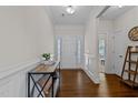 Elegant foyer with hardwood floors, decorative wainscoting, and a stylish console table at 3541 Fairstone Rd, Wake Forest, NC 27587