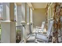 Cozy front porch featuring white rocking chairs, stone accents, and wrought iron railings at 3655 Pleasants Ridge Dr, Wake Forest, NC 27587