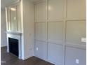 Living room showcasing fireplace with decorative trim and modern wainscoting details at 380 Pecan Valley Way, Four Oaks, NC 27524