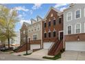 View of multiple home exteriors featuring brick and siding, private entries, and manicured landscaping at 4020 Abbey Park Way, Raleigh, NC 27612