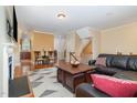 Bright living room with hardwood floors, fireplace, large couch and view to the dining area at 4020 Abbey Park Way, Raleigh, NC 27612