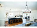 Spacious kitchen featuring a large island, custom lighting, and hardwood floors at 48 Blue Heron Ln, Roxboro, NC 27574