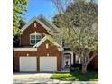 Beautiful two-story red brick home with a two-car garage and manicured lawn at 5036 Isabella Cannon Dr, Raleigh, NC 27612