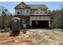 New home construction featuring an attached two car garage and covered front porch at 60 Moonraker Dr, Spring Hope, NC 27882