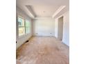 A well-lit living room showcases large window with trim, and a tray ceiling at 60 Moonraker Dr, Spring Hope, NC 27882