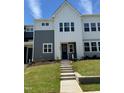 Charming two-story home with a modern farmhouse design, featuring gray and white siding and a well-manicured lawn at 607 Callan View Ave, Wake Forest, NC 27587