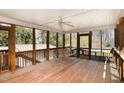Spacious screened porch with a wooden swing and ceiling fan, perfect for outdoor relaxation at 615 Sloan Dr, Cary, NC 27511