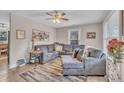 Inviting living room with a comfortable sectional sofa, stylish rug, and a ceiling fan for added comfort at 715 Shay Dr, Durham, NC 27704