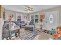 Cozy living room featuring a large sectional, neutral walls, natural light, and a view to the front door at 715 Shay Dr, Durham, NC 27704