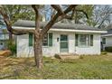Charming one-story home with white brick, green shutters, and mature trees at 740 Long Ave, Rocky Mount, NC 27801