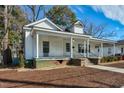 Quaint home showcasing a cozy covered porch, steps leading up to the entrance, and mature trees at 922 Nashville Rd, Rocky Mount, NC 27803