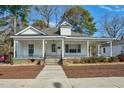 Inviting home featuring a covered porch, providing a relaxing outdoor space and classic curb appeal at 922 Nashville Rd, Rocky Mount, NC 27803