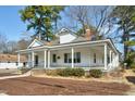 Classic house with a spacious covered porch, prominent columns, and surrounded by lush greenery at 922 Nashville Rd, Rocky Mount, NC 27803