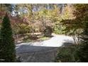 Circular driveway surrounded by trees and landscaping providing ample parking space at 10004 Liana Ln, Raleigh, NC 27613