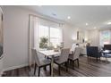 Well-lit dining area with a light wood table, upholstered chairs, and a large window at 1003 Red Roses Ave, Durham, NC 27703