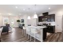 Open-concept kitchen with a granite island, stainless steel appliances, and a view into the living room at 1003 Red Roses Ave, Durham, NC 27703