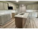Spacious kitchen with an island, stainless steel appliances, and plenty of cabinet space at 103 Oakfield Trace Dr, Four Oaks, NC 27524