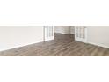 Spacious living area showcasing gray wood-look floors and bright white trim at 104 Pisgah St, Sanford, NC 27330