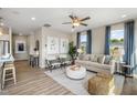 Cozy living room features ample natural light, a ceiling fan, and stylish furniture at 104 Siebold St, Garner, NC 27529