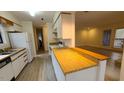 Functional kitchen featuring white cabinetry, updated countertops, and an open view into the living area at 12 Melstone Turn, Durham, NC 27707