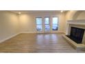 The open-concept living area features a fireplace and patio access for seamless indoor-outdoor living at 12 Melstone Turn, Durham, NC 27707