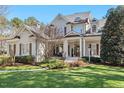 Charming two-story home boasts a manicured lawn and inviting front porch with detailed trim work at 1321 Colonial Club Rd, Wake Forest, NC 27587