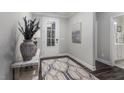 Inviting entryway with wood floors, stylish rug, and view to the bathroom at 1502 Red Roses Ave, Durham, NC 27703
