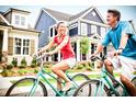 Charming street view with a couple riding bicycles and beautiful blue houses in the background at 1524 Level Stream Rd, Wendell, NC 27591