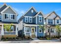 Charming two-story home with light blue siding, a welcoming porch, and a bright yellow front door at 1573 Piney Falls Dr, Wendell, NC 27591