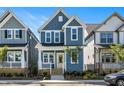 Beautiful two-story home featuring light blue siding, a welcoming porch, and a bright yellow front door at 1573 Piney Falls Dr, Wendell, NC 27591