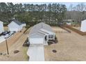 An aerial view showcases a fenced backyard, detached garage, and well-maintained landscaping surrounding the home at 175 Gill Farm Way, Franklinton, NC 27525