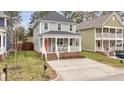 Attractive gray two-story home with a cozy front porch and brick-lined stairs at 215 Seventh St, Wake Forest, NC 27587