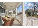 Inviting front porch featuring wicker seating and a view of the peaceful neighborhood at 215 Seventh St, Wake Forest, NC 27587