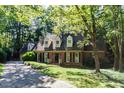 Charming home with lush green lawn, mature trees and long driveway at 3005 Woodgreen Dr, Raleigh, NC 27607