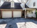 Spacious two-car garage with brick facade and driveway at 3005 Woodgreen Dr, Raleigh, NC 27607