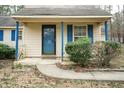 Close up of front porch featuring blue columns and shutters and a quaint, welcoming entrance at 3323 Nantuckett Ave, Durham, NC 27703