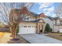 Charming two-story home featuring a stone-accented entrance, attached two-car garage, and well-maintained landscaping at 3910 Wedonia Dr, Cary, NC 27519
