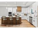 Bright kitchen with white cabinets, stainless steel appliances, and a large center island with bar stool seating at 4017 Mebane Oaks Rd, Mebane, NC 27302