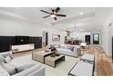Open-concept living room with modern decor, stylish furniture, and seamless flow into the kitchen and dining area at 4017 Mebane Oaks Rd, Mebane, NC 27302